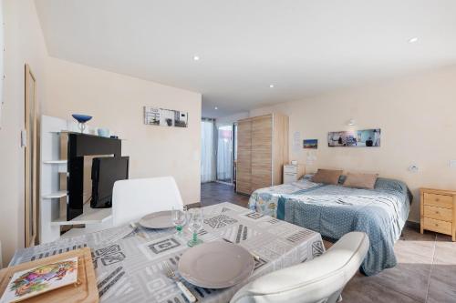 a room with a bed and a table and a bed at Chambre d'hote chez Odile in Plougoulm