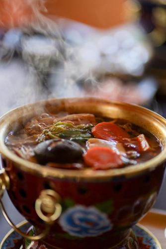 a cup of soup sitting on a table at 結びの小宿 縁 by Wellbe in Kobe