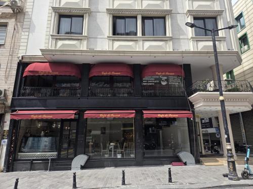 a store front with red awnings on a building at The Parma Hotel Downtown in Istanbul