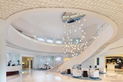 a spiral staircase in a building with a lobby at JA Ocean View Hotel, Jumeirah Beach Dubai in Dubai