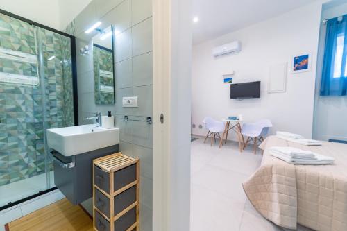 a bathroom with a sink and a bed in a room at Sale e Salsedine in Bari