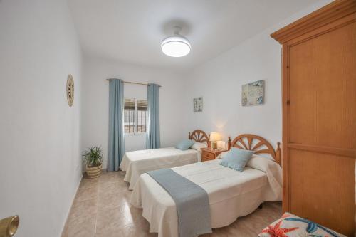 a bedroom with two beds in a room at Isabel Casa del Mar in Conil de la Frontera