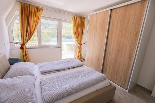 a bedroom with two beds and a window at Apartment Baki in Jajce