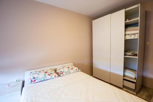 a small bedroom with a bed and a closet at "Life is Easy Apt" in Varna City