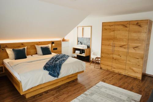 a bedroom with a large bed and a dresser at Ferienhof Egger in Tettnang