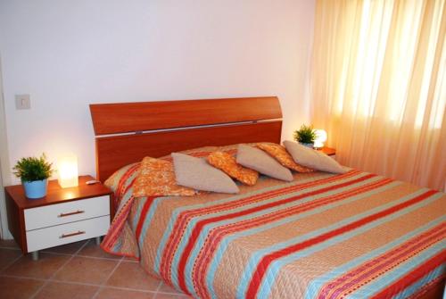 a bedroom with a bed with two plants on it at Santis Appartament in Grado