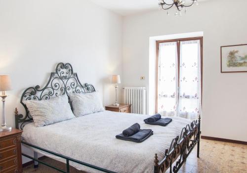 a bedroom with a bed with two towels on it at La Terrazza sul Giardino in Asti