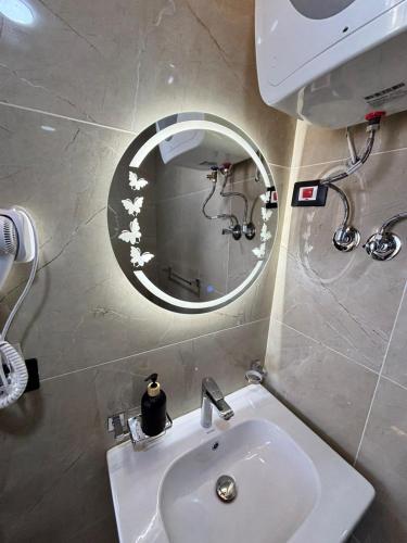 a bathroom with a sink and a mirror at Azurea Suites in Alexandria