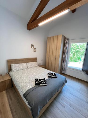 a bedroom with a bed with two pairs of shoes on it at Eko apartamentos Astelarra in Muxika