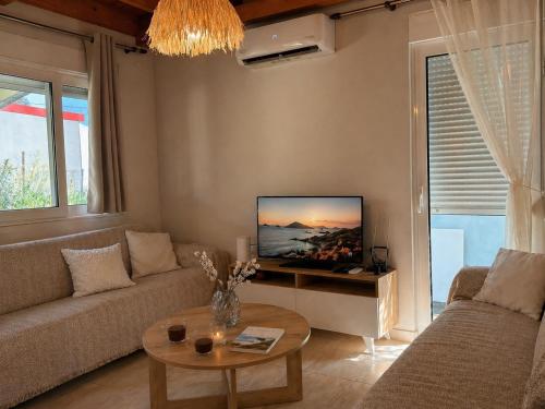 a living room with a couch and a table at Wooden Loft 3min Walk to Beach in Alexandroupoli