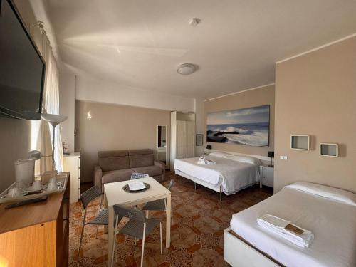 a hotel room with a bed and a couch at B&B Residenza Leonardo in Falconara Marittima
