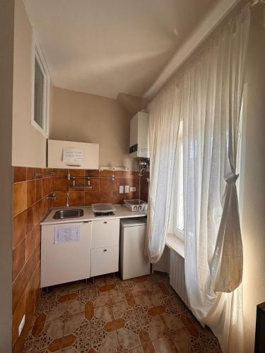 a small kitchen with a sink and a window at B&B Residenza Leonardo in Falconara Marittima