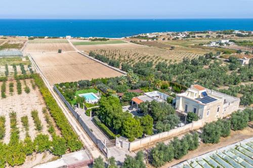 an aerial view of a house with a field and the ocean at Blue Coast Luxury Private Villa, Pool, Jacuzzi, Guesthouse in Bisceglie