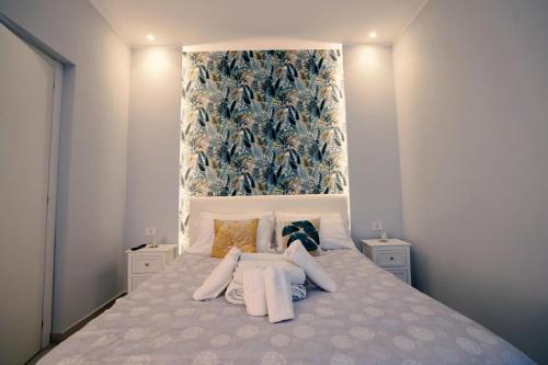a bedroom with a large bed with white pillows at La casa di Penelope in Catania