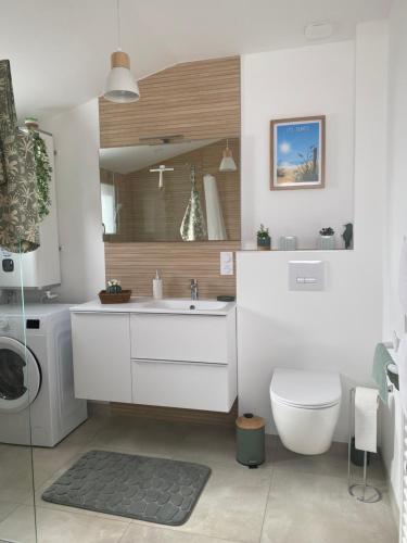 a bathroom with a white sink and a toilet at Studio La Parenthèse Sablaise - 3 étoiles in Les Sables-d'Olonne