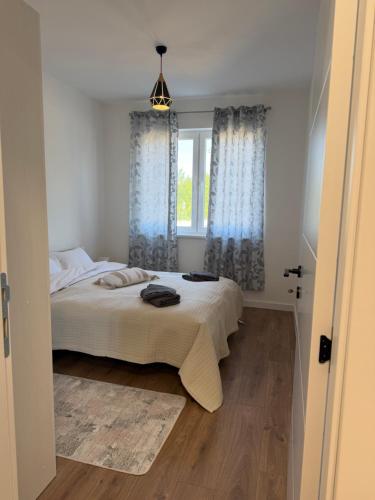 a bedroom with a bed and a window at City Break Sarajevo in Sarajevo