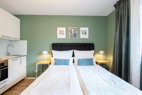 a bedroom with a large bed with blue walls at Sali Homes - Wahnfried No 1 City Apartment Balcony in Bayreuth