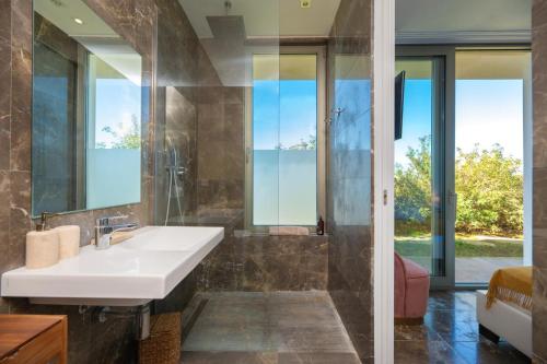 a bathroom with a sink and a mirror at Villa Roca Llisa in Santa Eularia des Riu