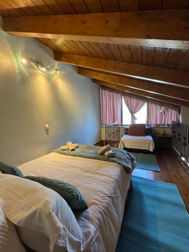 a bedroom with two beds and a large window at Frigias 4 in Arachova