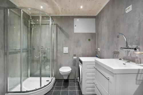 a bathroom with a shower and a toilet and a sink at Sea house in beautiful surroundings in Haram