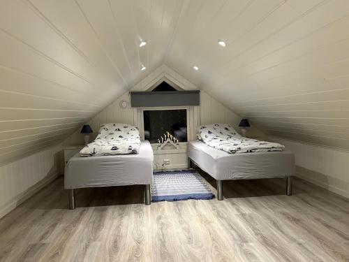 a room with two beds in a attic at Sea house in beautiful surroundings in Haram