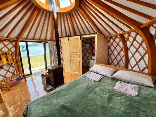 a bedroom in a yurt with a bed and a stove at Maikhan Tolgoi lodge in Horgo