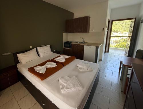 a bedroom with a bed with towels on it at Kallisti in Ormos Panagias