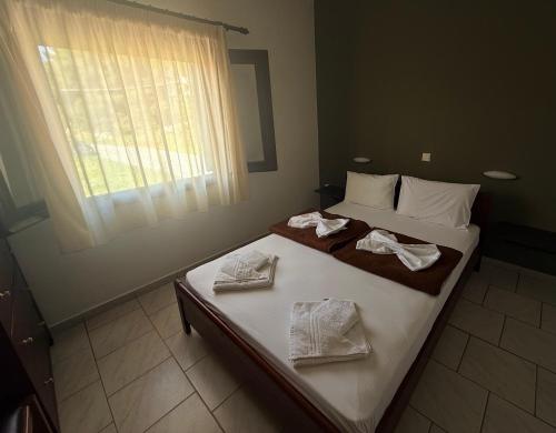 a bedroom with two beds with towels on them at Kallisti in Ormos Panagias
