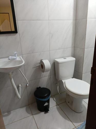 a bathroom with a toilet and a sink at Hotel Veleiro de Porto in Porto De Galinhas