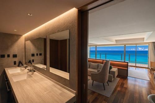 a living room with a view of the ocean at RAV RESORT Okinawa in Yomitan