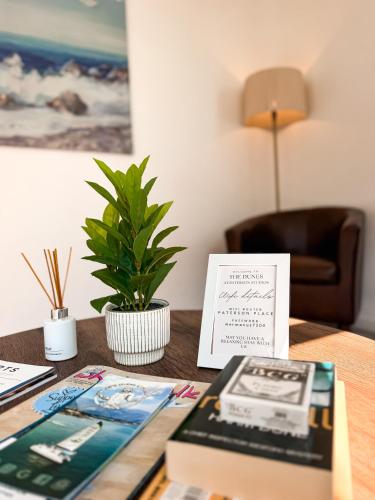 a table with a book and a card on it at Paterson Place Studios in Hermanus