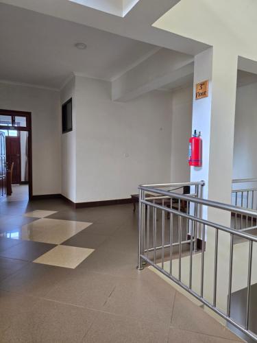 an empty room with a staircase and a fire hydrant at Kilimanjaro Magic in Moshi