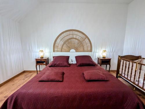 a bedroom with a large bed with a red blanket at Longère à la campagne rénovée à neuf in Le Lys-Saint-Georges