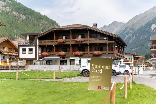 a summer card sign in front of a building at Hotel Garni Maria Theresia - Official Ötztal Summer Card Partner in Sölden