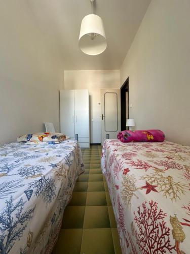 a bedroom with two beds and a floor at CORALLO 31 con Piscina in Lido delle Nazioni