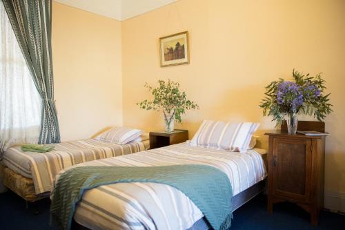 A bed or beds in a room at Boorowa Hotel
