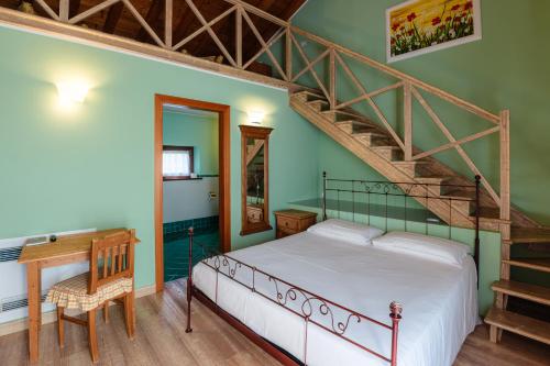 a bedroom with a bed and a staircase at Agriturismo Althea in Vittorio Veneto