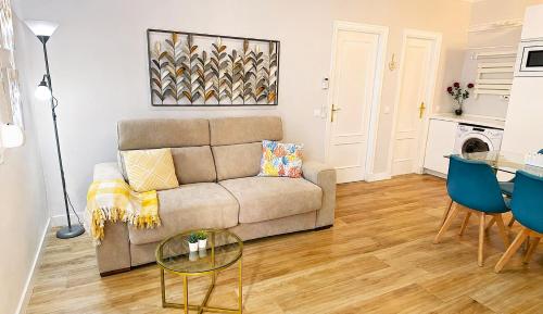 a living room with a couch and a table at Coral Apartment La Cala Beach in La Cala de Mijas