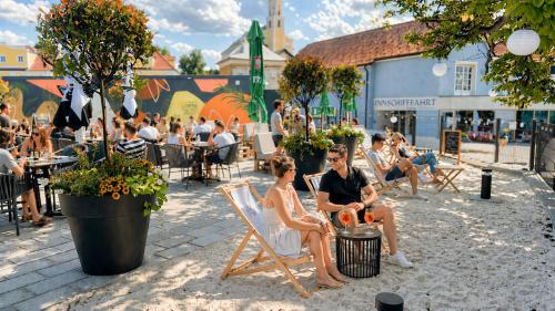 a group of people sitting in chairs on the beach at Baumgartner Camping am Inn in Schärding