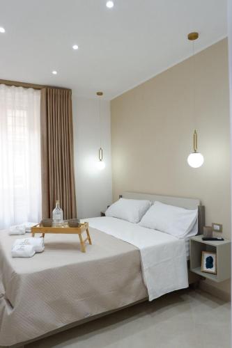 a bedroom with a large bed with a table on it at Dimora Don Ferdinando in Naples