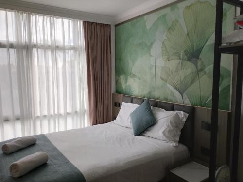 a bedroom with a bed and a large window at Airway Motel in Brisbane