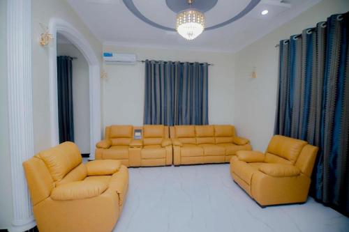 a living room with two couches and two chairs at Zanzibar Residence in Zanzibar City