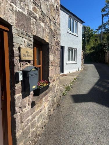 a stone building with a mailbox on the side of it at The Old Stable in Abergavenny