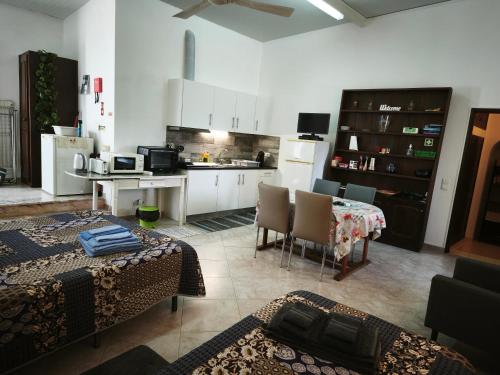 a kitchen with a table and chairs and a kitchen with white cabinets at Quinta do Medronhal Faro - casas de férias medronhal in Faro