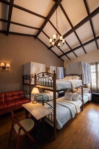 a room with three bunk beds and a couch at Great Shanghai Guesthouse in George Town