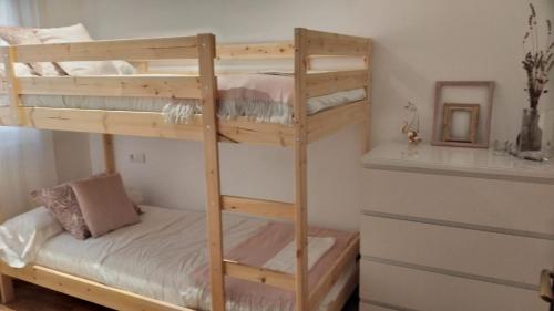 a wooden bunk bed in a small room at Apartamento Markina Xemein in Marquina-Jemein