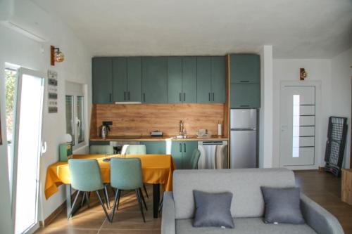 a kitchen with a table and chairs in a room at Olive Grove Luxury with private POOL in Bar