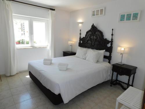 a bedroom with a large bed and a window at Luz Beach Center in Luz