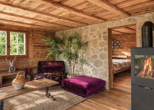 a living room with a fireplace in a log cabin at Chalet with fireplace and sauna in Meiringen