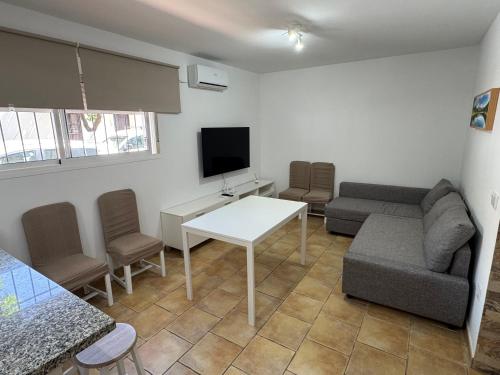a living room with a couch and a table at Velazquez in Lora del Río